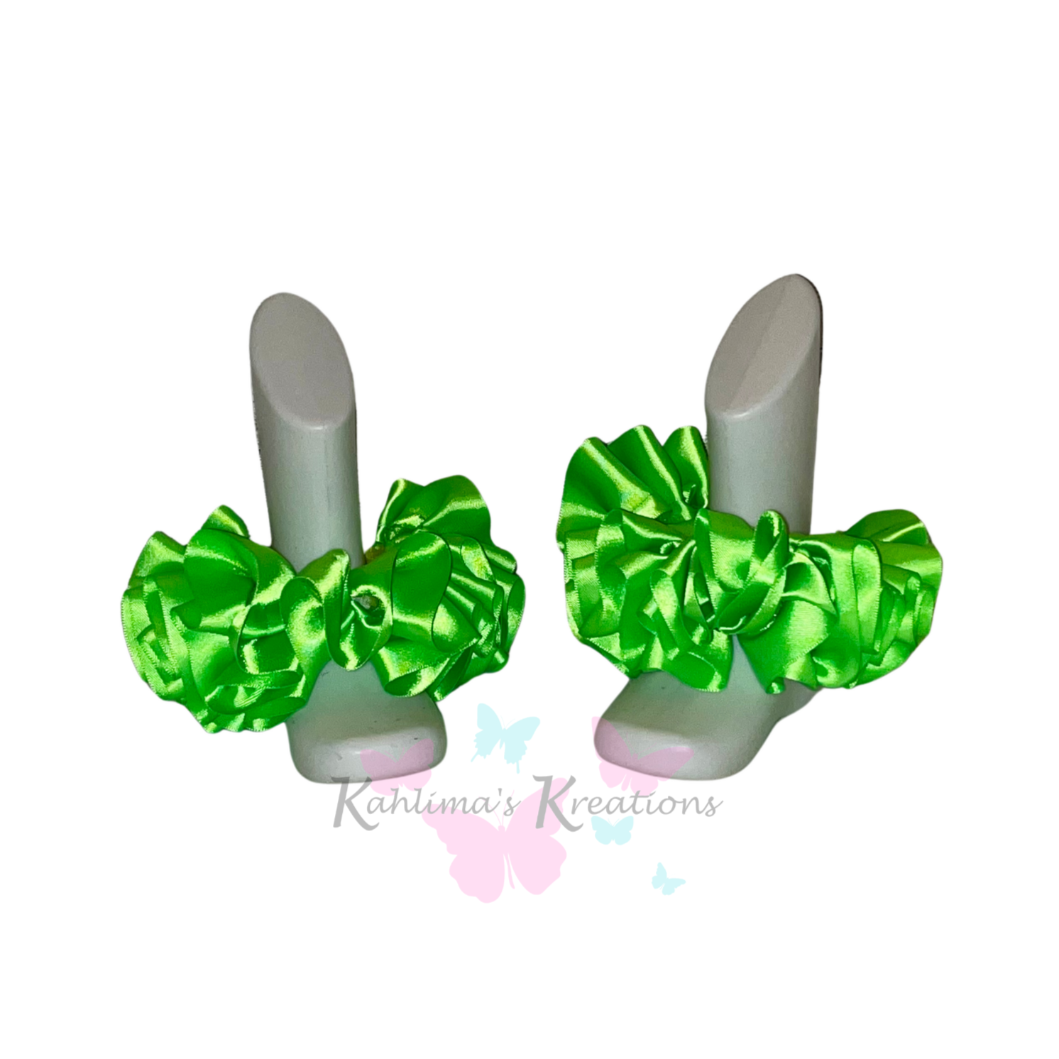 Pair of apple green ruffled anklets on white background