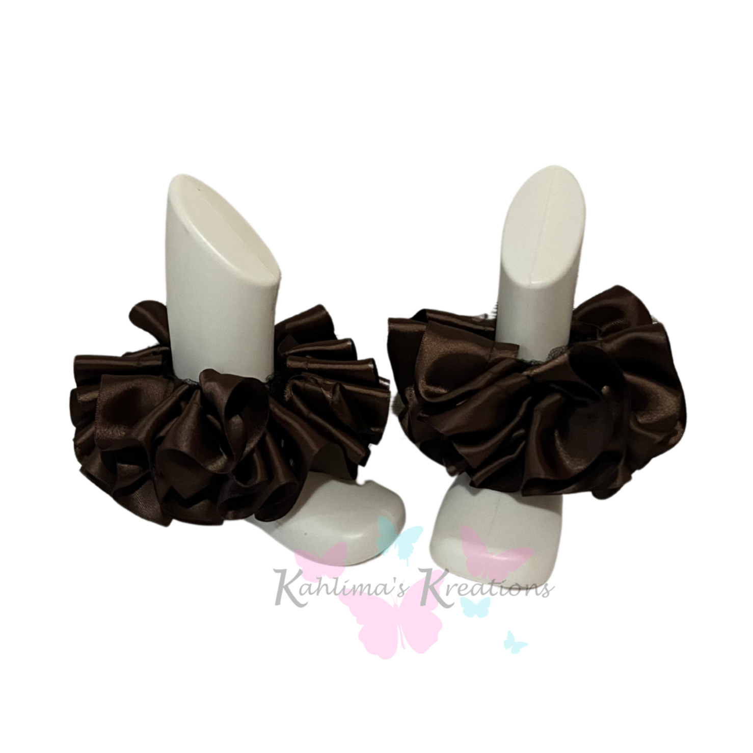 Pair of brown ruffled anklets on white background