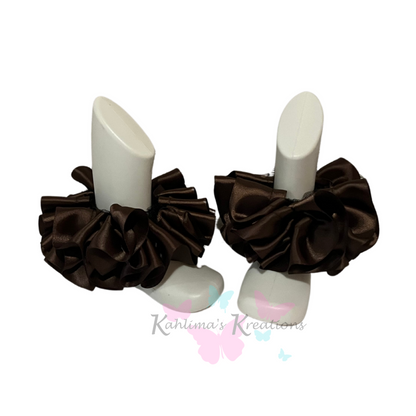 Pair of brown ruffled anklets on white background