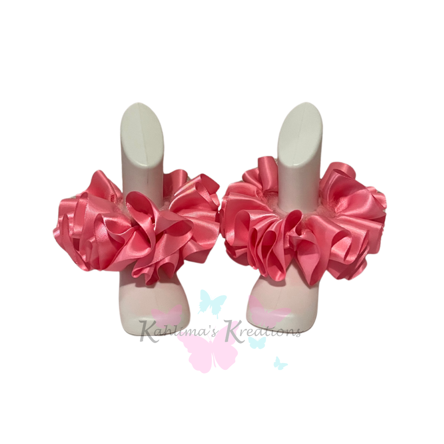 Pair of hot pink ruffled anklets on white background