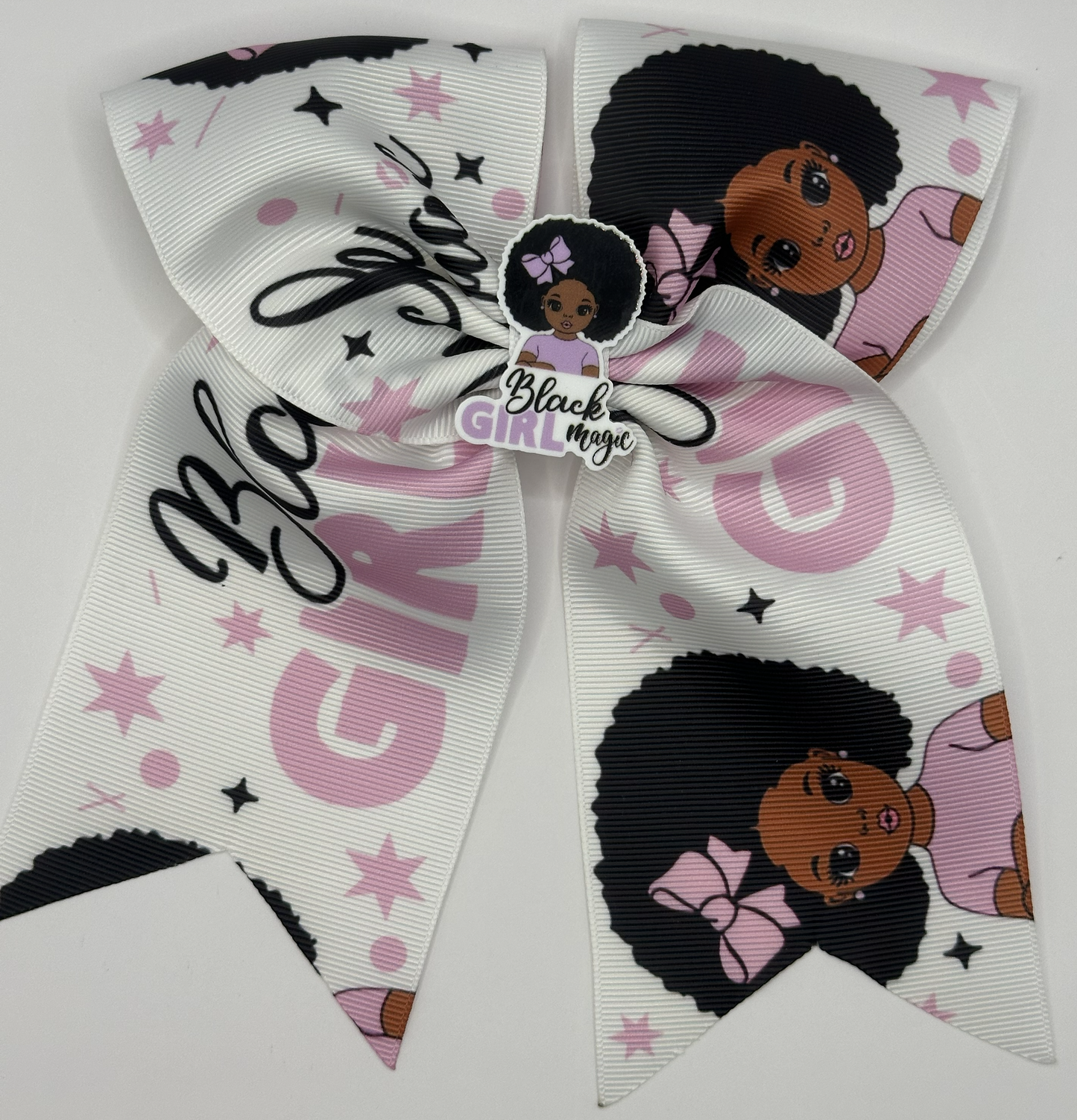 Large decorative bow with 'Black Girl Magic' text and images of a girl with an afro on a white background.