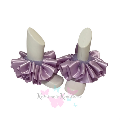 Pair of lavender ruffled anklets on white background