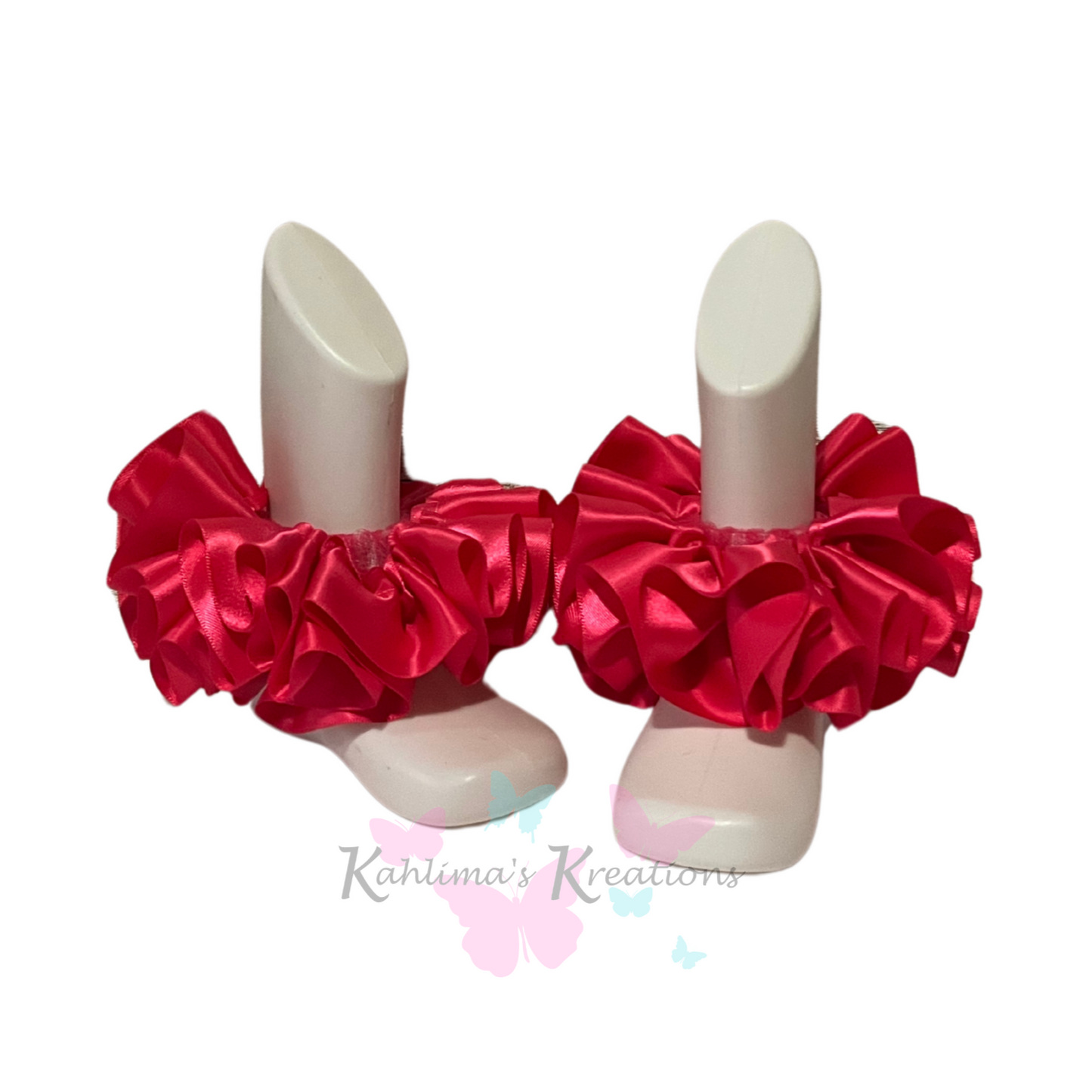Pair of shocking pink ruffled anklets on white background