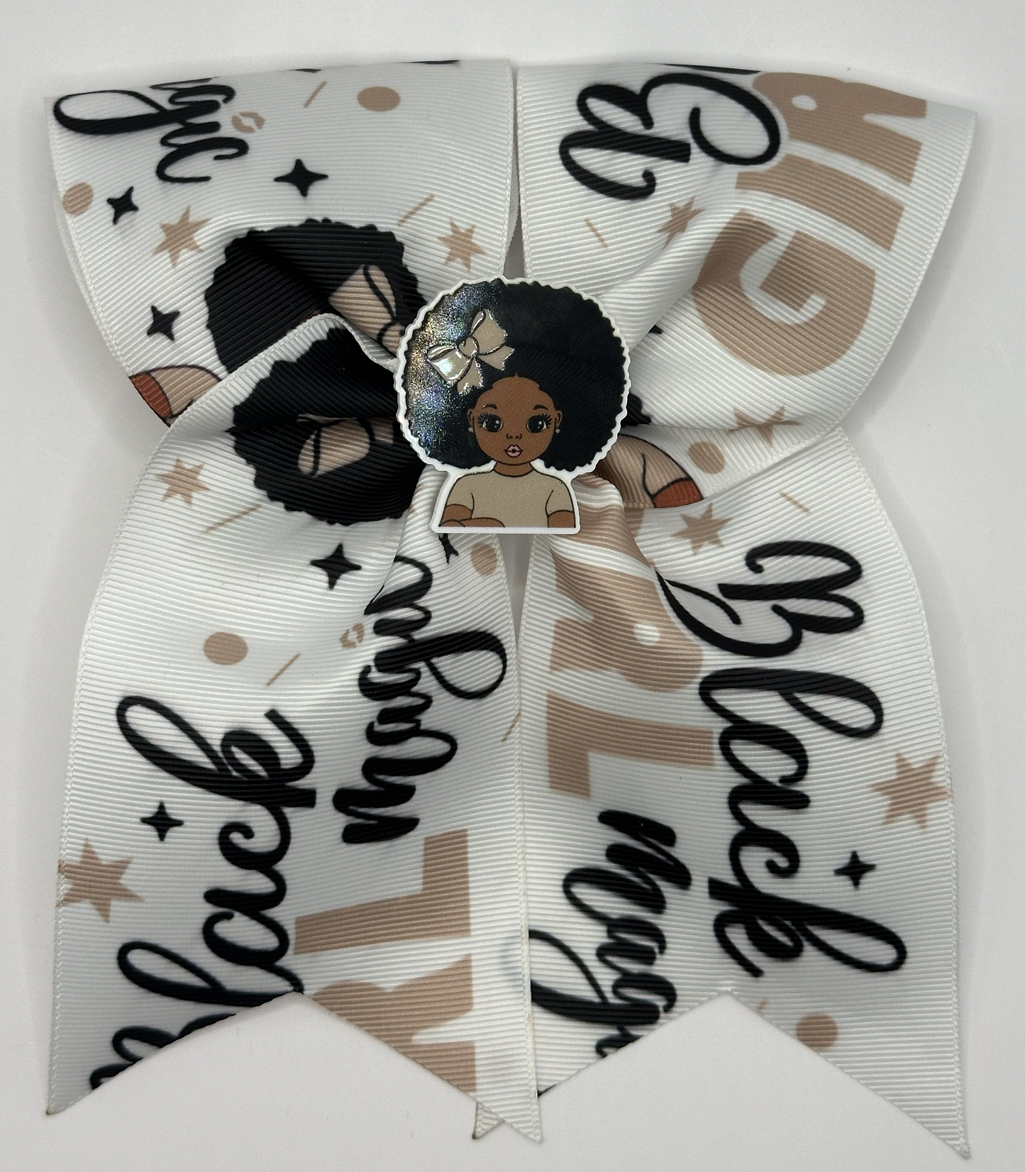 Bow with 'Black Magic' text and a central sticker of a person with an afro on a white background