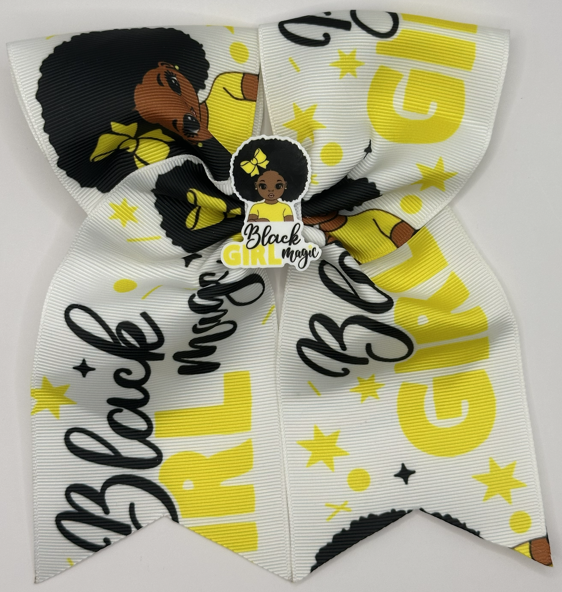 Hair bow with 'Black Girl Magic' text and stars on a white background
